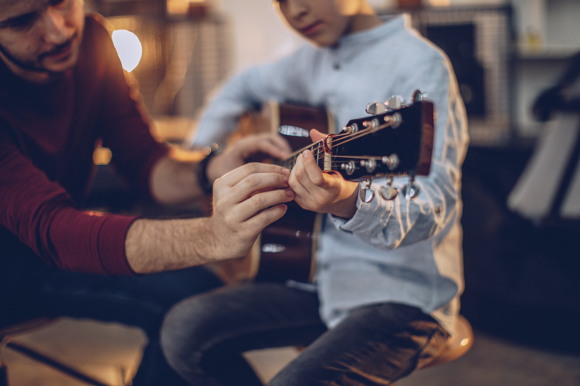 Boy playing guitar at music class